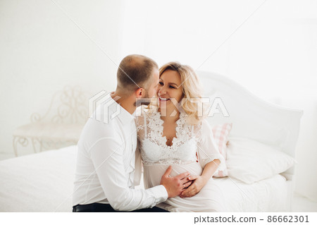 Beautiful couple embracing stomach and touching Beautiful couple embracing stomach and touching 86662301
