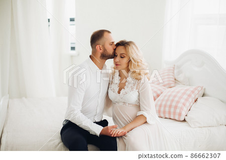 Beautiful couple embracing stomach and touching Beautiful couple embracing stomach and touching 86662307