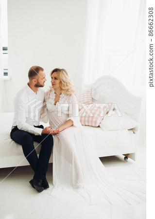 Beautiful couple embracing stomach and touching Beautiful couple embracing stomach and touching 86662308