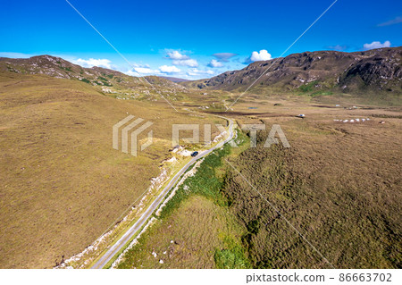 The road to An Port between Ardara and Glencolumbkille in County Donegal - Ireland. 86663702