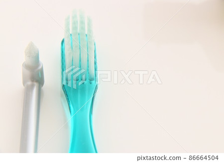 Head part of toothbrush and tuft brush placed on the tile 86664504