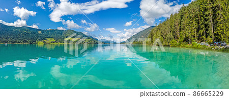 Panoramic view over turquoise lake Weissensee in Austrian province Carinthia during daytime Panoramic view over turquoise lake Weissensee in Austrian province Carinthia during daytime 86665229