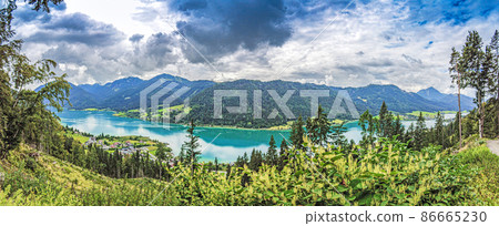 Panoramic view over turquoise lake Weissensee in Austrian province Carinthia during daytime Panoramic view over turquoise lake Weissensee in Austrian province Carinthia during daytime 86665230