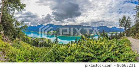 Panoramic view over turquoise lake Weissensee in Austrian province Carinthia during daytime Panoramic view over turquoise lake Weissensee in Austrian province Carinthia during daytime 86665231