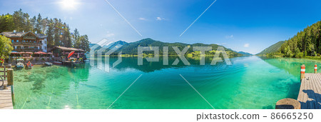 Panoramic picture over Weissensee lake in Austria with turquoise water from view point Ronacher Fels in summer Panoramic picture over Weissensee lake in Austria with turquoise water from view point Ronacher Fels in summer 86665250