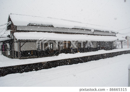 Retro station building in the snow 86665315