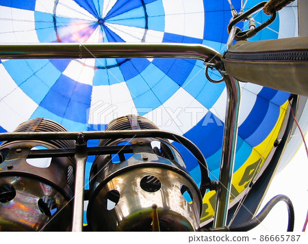 A burner that blows flames inside a hot air balloon gondola 86665787