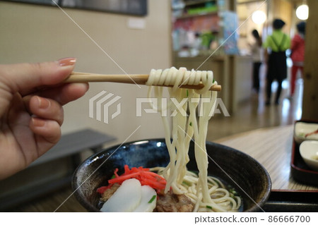 Someone picked up the ramen with chopsticks Someone picked up the ramen with chopsticks 86666700