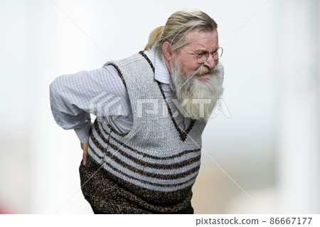 Old man with gray beard suffering from backache on blurred background. 86667177