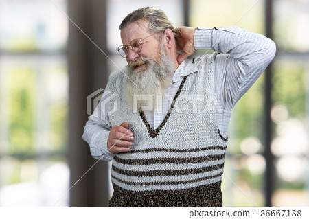 Stressed senior man touching his hand on nape. Pain concept. Stressed senior man touching his hand on nape. Pain concept. 86667188