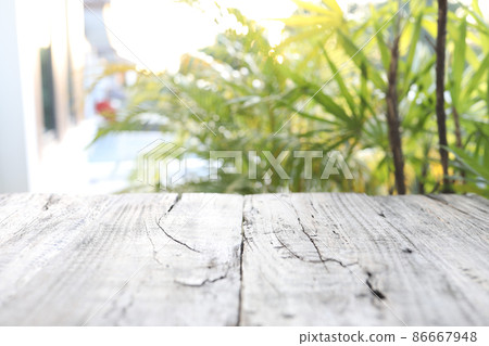 Wooden plank surface with green nature background Wooden plank surface with green nature background 86667948