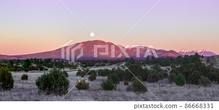 Full moon rises over Humphreys Peak near Grand Canyon in Arizona in the evening at wintertime Full moon rises over Humphreys Peak near Grand Canyon in Arizona in the evening at wintertime 86668331