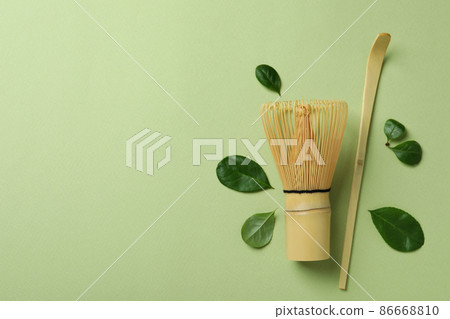 Japanese tea accessories on green background, space for text Japanese tea accessories on green background, space for text 86668810