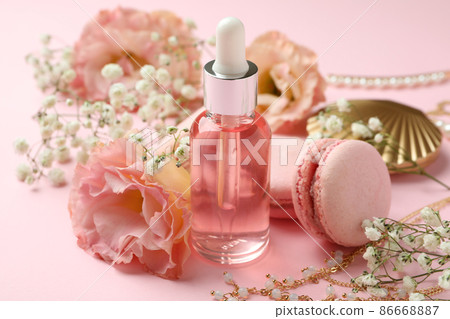 Female accessories and macaroons on pink background Female accessories and macaroons on pink background 86668887