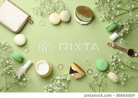 Female accessories and macaroons on green background Female accessories and macaroons on green background 86668889