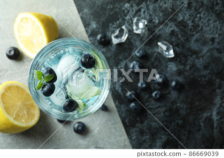 Glass of summer cocktail and ingredients on two tone background 86669039