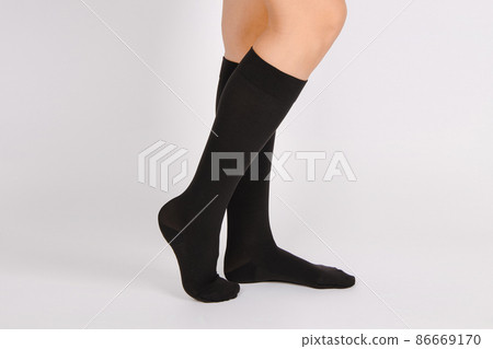 Medical Compression Stockings for varicose veins and venouse therapy. Compression Hosiery. Sock for sports isolated on white background. Black color socks mock up for advertising, branding, design. Medical Compression Stockings for varicose veins and venouse therapy. Compression Hosiery. Sock for sports isolated on white background. Black color socks mock up for advertising, branding, design. 86669170