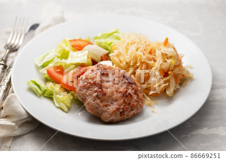 grilled hamburger with salad and salted salas cabbage withcarrot on white plate 86669251