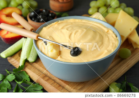 Concept of delicious food with fondue, close up Concept of delicious food with fondue, close up 86669278