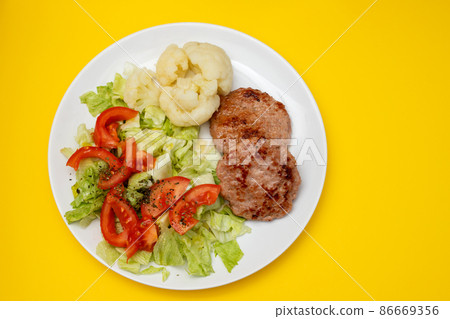 ground meat with fresh salad and boiled cauliflower on white plate ground meat with fresh salad and boiled cauliflower on white plate 86669356