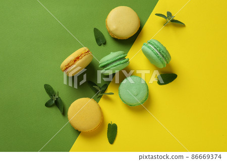 Concept of tasty dessert with macarons on two tone background Concept of tasty dessert with macarons on two tone background 86669374