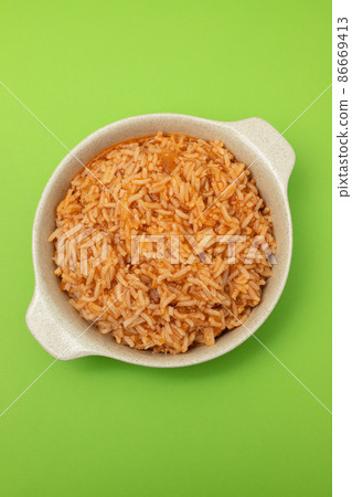 tomato rice on the dish on green background 86669413
