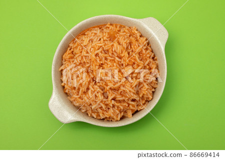 tomato rice on the dish on green background tomato rice on the dish on green background 86669414