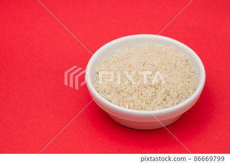 raw rice on white bowl on gray ceramic raw rice on white bowl on gray ceramic 86669799
