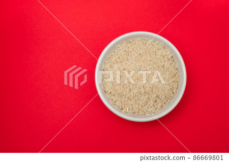 raw rice on white bowl on gray ceramic raw rice on white bowl on gray ceramic 86669801