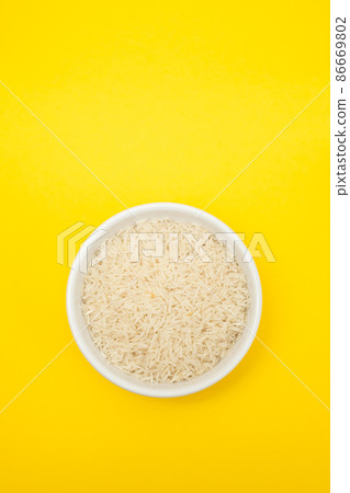 raw rice on white bowl on gray ceramic raw rice on white bowl on gray ceramic 86669802