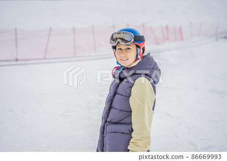 Woman learning to ski. Young woman skiing on a snowy road in the mountains 86669993