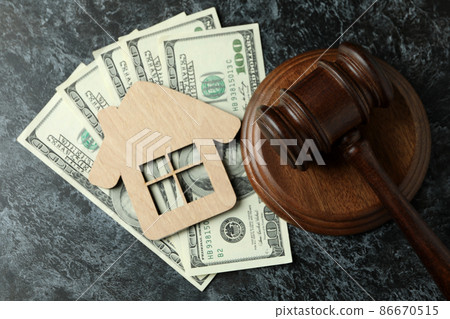 Judge gavel, dollars and wooden house on black smokey table Judge gavel, dollars and wooden house on black smokey table 86670515
