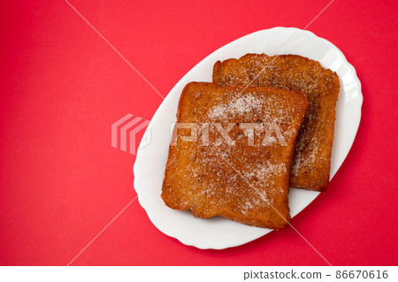typical portuguese Christmas dessert fried bread with cinnamon 86670616