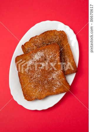 typical portuguese Christmas dessert fried bread with cinnamon 86670617