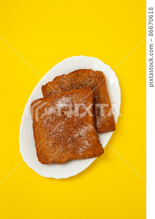 typical portuguese Christmas dessert fried bread with cinnamon 86670618