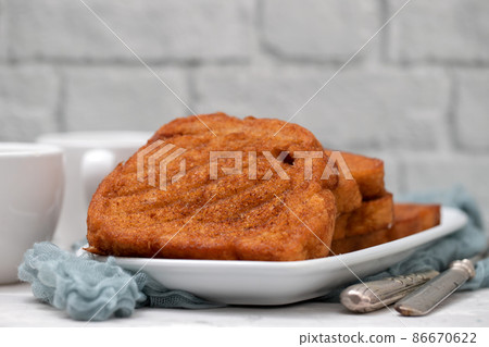 typical portuguese Christmas dessert fried bread with cinnamon 86670622