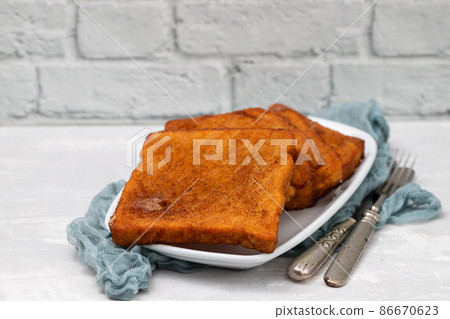 typical portuguese Christmas dessert fried bread with cinnamon 86670623