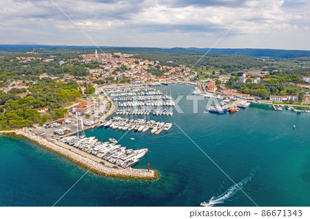 Aerial panoramic drone picture of Vrsar harbour in Croatia with turquoise water during daytime 86671343