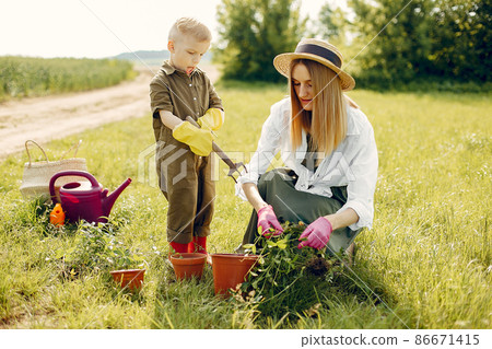 Beautiful mother with little son in a summer field Beautiful mother with little son in a summer field 86671415