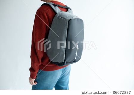stylish hipster male holding modern backpack bag on white background stylish hipster male holding modern backpack bag on white background 86672887
