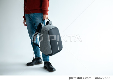 stylish hipster male holding modern backpack bag on white background stylish hipster male holding modern backpack bag on white background 86672888