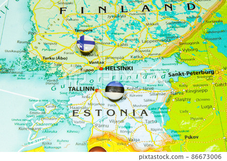 Estonian national flag pinned on Europe map. Macro Close up picture of country Estonia on a colorful and blurry world map globe with focus to capital Tallin. Push pin on atlas, marker of destination. Estonian national flag pinned on Europe map. Macro Close up picture of country Estonia on a colorful and blurry world map globe with focus to capital Tallin. Push pin on atlas, marker of destination. 86673006