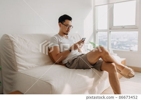 Middle age man with long eye sight try to look at the smartphone. Middle age man with long eye sight try to look at the smartphone. 86673452