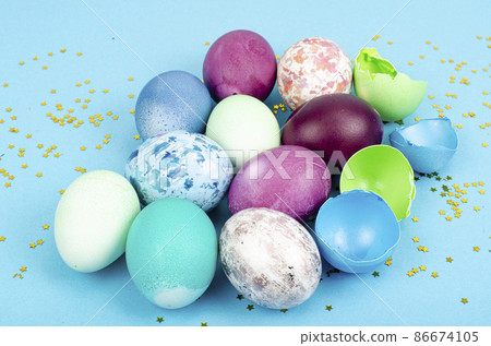 Decorated handmade Easter eggs for the holiday season on blue background. Creative minimal abstract concept. Studio Photo Decorated handmade Easter eggs for the holiday season on blue background. Creative minimal abstract concept. Studio Photo 86674105