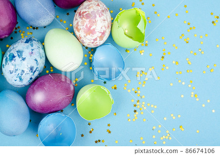 Decorated handmade Easter eggs for the holiday season on blue background. Creative minimal abstract concept. Studio Photo 86674106
