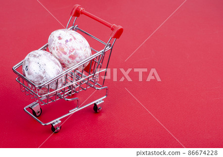 Grocery supermarket cart filled with chicken eggs. Concept of preparing for Easter, buying food. Space for text. Studio Photo Grocery supermarket cart filled with chicken eggs. Concept of preparing for Easter, buying food. Space for text. Studio Photo 86674228