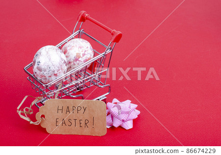 Grocery supermarket cart filled with chicken eggs. Concept of preparing for Easter, buying food. Space for text. Studio Photo 86674229