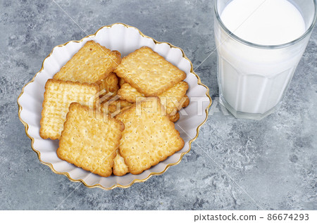 Delicious cookies and glass of milk on bright background. Studio Photo 86674293