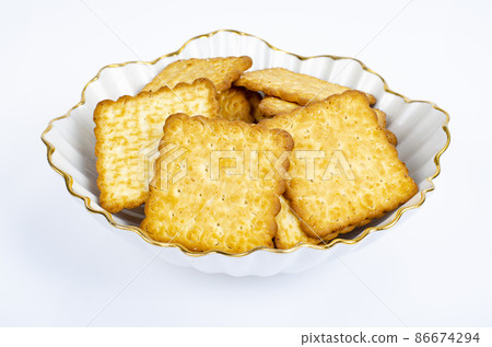 Minimalist pile delicious cookies. Salty biscuit cracker on white background. Studio Photo Minimalist pile delicious cookies. Salty biscuit cracker on white background. Studio Photo 86674294