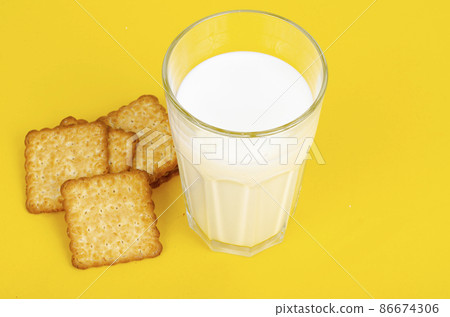 Delicious cookies and glass of milk on bright background. Studio Photo Delicious cookies and glass of milk on bright background. Studio Photo 86674306